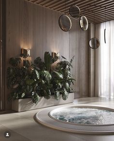 an indoor hot tub with plants in the middle and hanging lights on the wall behind it