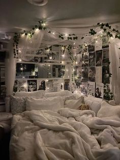 an unmade bed with white sheets and lights