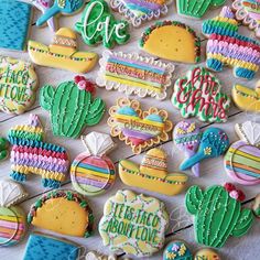 colorful decorated cookies are arranged on a table