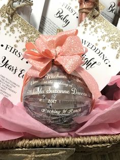 a basket filled with lots of pink and silver items next to some cards on top of each other