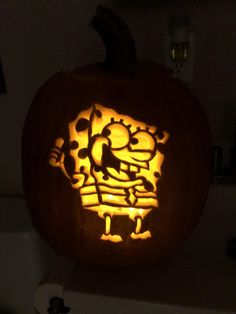 a carved pumpkin with an image of a man on it's face in the dark