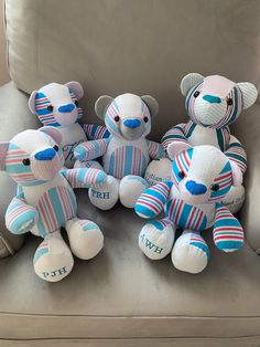 several stuffed animals are sitting on a couch with the word faith spelled in blue and red stripes