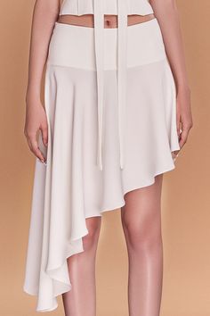 This luxurious piece features a unique asymmetrical design and is made of high-quality crepe fabric, draping elegantly to flatter your curves. Perfect for a day at the office or a night out, it's a must-have addition to your wardrobe. Length: 35cm (Shortest), 81cm (Longest) Elegant Evening Draped Skirt With High-low Hem, Asymmetrical Silk Evening Skirt, Asymmetrical Fitted Silk Bottoms, Silk Bottoms With Asymmetrical Hem For Party, Formal Silk Skirt With Asymmetrical Hem, Chic Draped Skirt For Formal Occasions, Silk Party Bottoms With Asymmetrical Hem, Evening Skirt With Asymmetrical Hem, Asymmetrical Silk Bottoms For Party