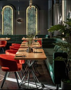 an empty restaurant with green and red chairs