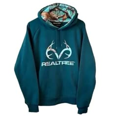 Realtree Womens Camo Inset Popover Hoodie Teal Side Inset Pocket Lined Hood On Seam Connected Pocket Fabric: Body, Outer Hood And Sleeves: 80% Cotton, 20% Polyester Hood Lining, Side Panels And Pocket Lining: 100% Polyester Cuffs And Hem: 95% Polyester, 5% Elastane Sizing: Garment Chest: S: 21 ¾In. M: 23in. L: 24 ¼In. Front Body Length-High Shoulder: S: 25 ¼In. M: 26in. L: 26 ¾In Realtree Outfits For Women, Country Sweatshirts Hoodie, Realtree Womens Clothing, Viral Camo Hoodie, Camo Shark Hoodie, Hollister Camo Hoodie, Job Clothes, Camo Sweatshirt, Cowgirl Stuff