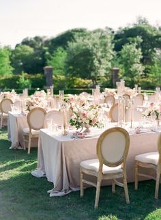 an outdoor wedding reception set up with tables and chairs