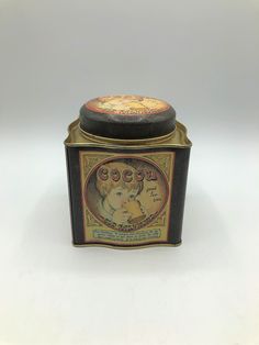 an old fashioned tin canister with a label on the lid that says, love