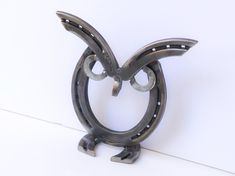 a metal object that looks like an animal's head with two horns on it