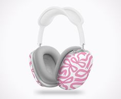 a pair of headphones with pink and white designs on the front, against a white background