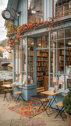 the outside of a bookstore with tables and chairs