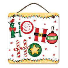 a christmas sign hanging from the side of a wall with holiday decorations and candy canes