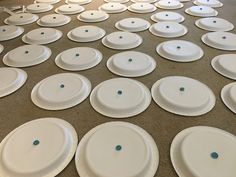 many white plates are laid out on the floor