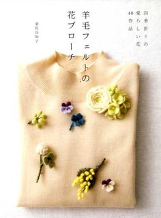 a sweater with flowers pinned to it