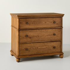 a wooden dresser with three drawers on one side and two small drawers on the other