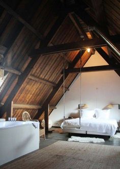 a bedroom with a swing bed in the middle and a bathtub next to it