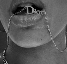 an advertisement for dior with a woman's mouth chained to the word dior