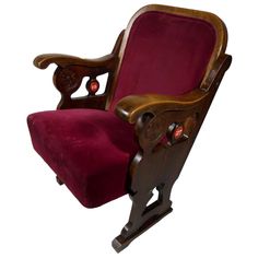 an old wooden rocking chair with a red velvet seat and back cushion on white background