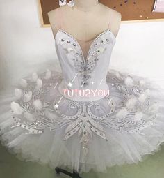 a white tutu dress on display in a room