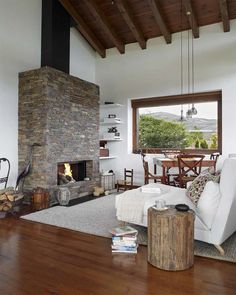 a living room filled with furniture and a fire place in the middle of a room