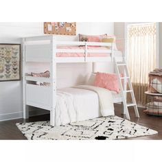 a white bunk bed sitting on top of a wooden floor next to a rug and window