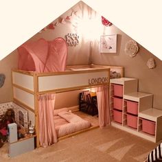 a loft bed with pink curtains in a child's bedroom