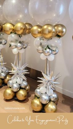 some balloons are on the table with gold and silver decorations