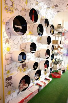 there are many shelves on the wall in this room with children's books and toys