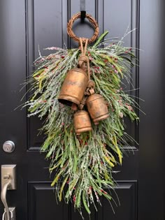 a wreath with bells hanging on the front door