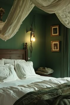 a bedroom with green walls and white bedding