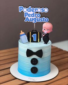 a blue and white cake with a baby on top