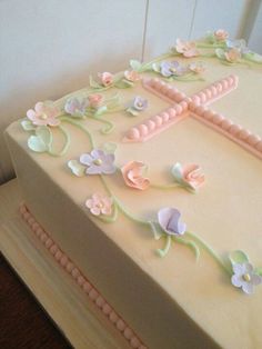 a white cake with pink and blue flowers on it