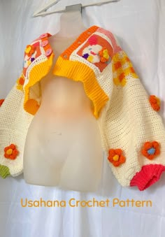 a crocheted sweater with flowers on it