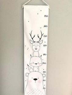 a white wall hanging with a drawing of two deer on it's face and numbers