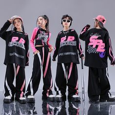 three girls in matching tracksuits are posing for the camera