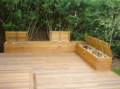 an outdoor built in seating area with plenty of storage and lighting attached to side posts