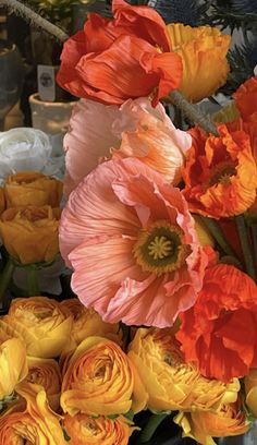 an arrangement of flowers in a vase on a table