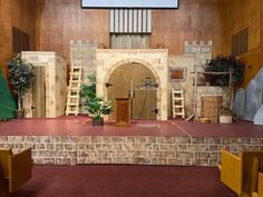 the stage is set up for an event with stone walls and brick steps leading to it