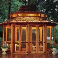 a small wooden gazebo sitting in the middle of a park