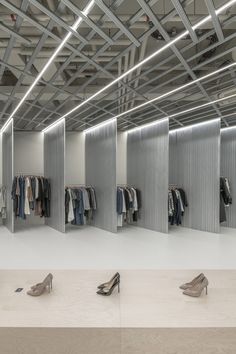 an empty clothing store with lots of shoes on the floor