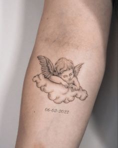 a small angel tattoo on the arm