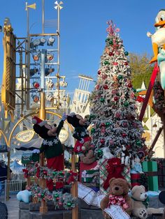 mickey mouse and donald duck in front of a christmas tree at the disneyland california theme park