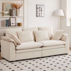 a living room with a white couch and black and white checkered floor tiles on the floor