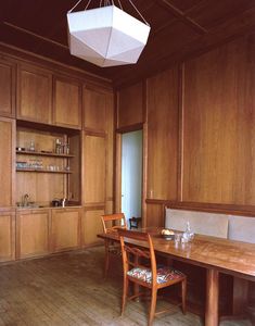 a dining room with wooden walls and flooring