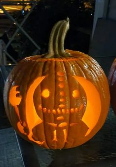 two pumpkins with carved faces on them