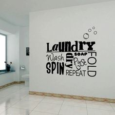 a bathroom wall with the words laundry, wash your hands, spin and repeat on it