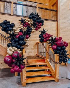 some black and red balloons are on the stairs