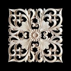 an intricately carved piece of wood on a black background