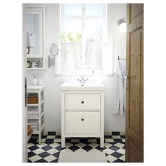 a bathroom with black and white checkered flooring