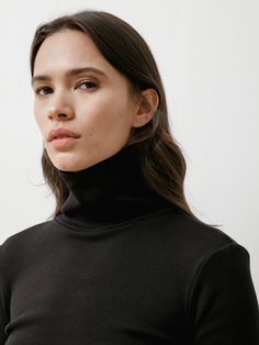 Classic body con turtleneck.Feels like: Super-soft yet substantial, brushed stretch knit 59% Cotton; 40% Polyester; 1% Spandex | Dry clean onlyMade in Vancouver, Canada. Fit: Annapurna is 5'-7" | Chest: 30B | Waist: 24" | Hips: 34" and she is wearing a S/M _______________________________________________________ Fit Guide*: S/M: Chest Width: 15" Sleeve Length: 22.5" Collar to shoulder seam: 3.75" Collar to Hem Length: 23.5" M/L: Chest Width: 15.5" Sleeve Length: 24" Collar to shoulder seam: 4" Co Black High Neck Turtleneck For Work, Sleek High Neck Turtleneck For Layering, Sleek Black Long Sleeve Turtleneck, Sleek Turtleneck Mock Neck Top For Layering, High Neck Turtleneck With Thumbholes For Layering, Sleek Funnel Neck Turtleneck For Winter, Black Turtleneck For Layering, Turtleneck With Thumbholes For Layering, Sleek Black Mock Neck Top For Fall