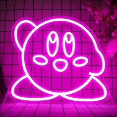 a pink neon sign with an image of a cat's face in the center